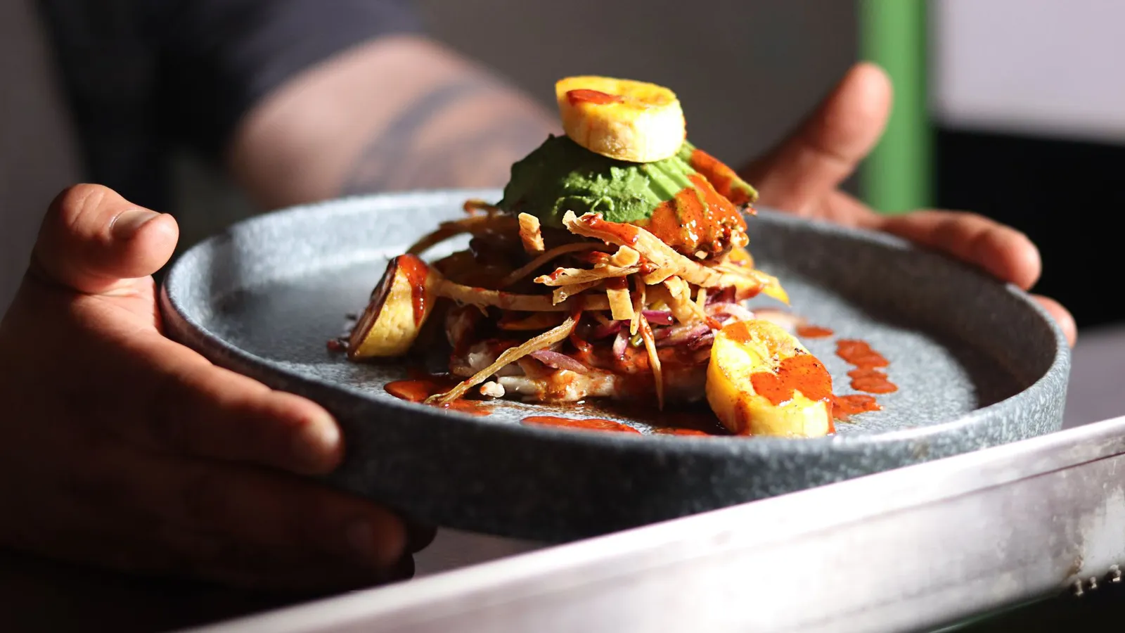 A delicious gourmet meal featuring plantains and sauce, elegantly plated and ready to serve.