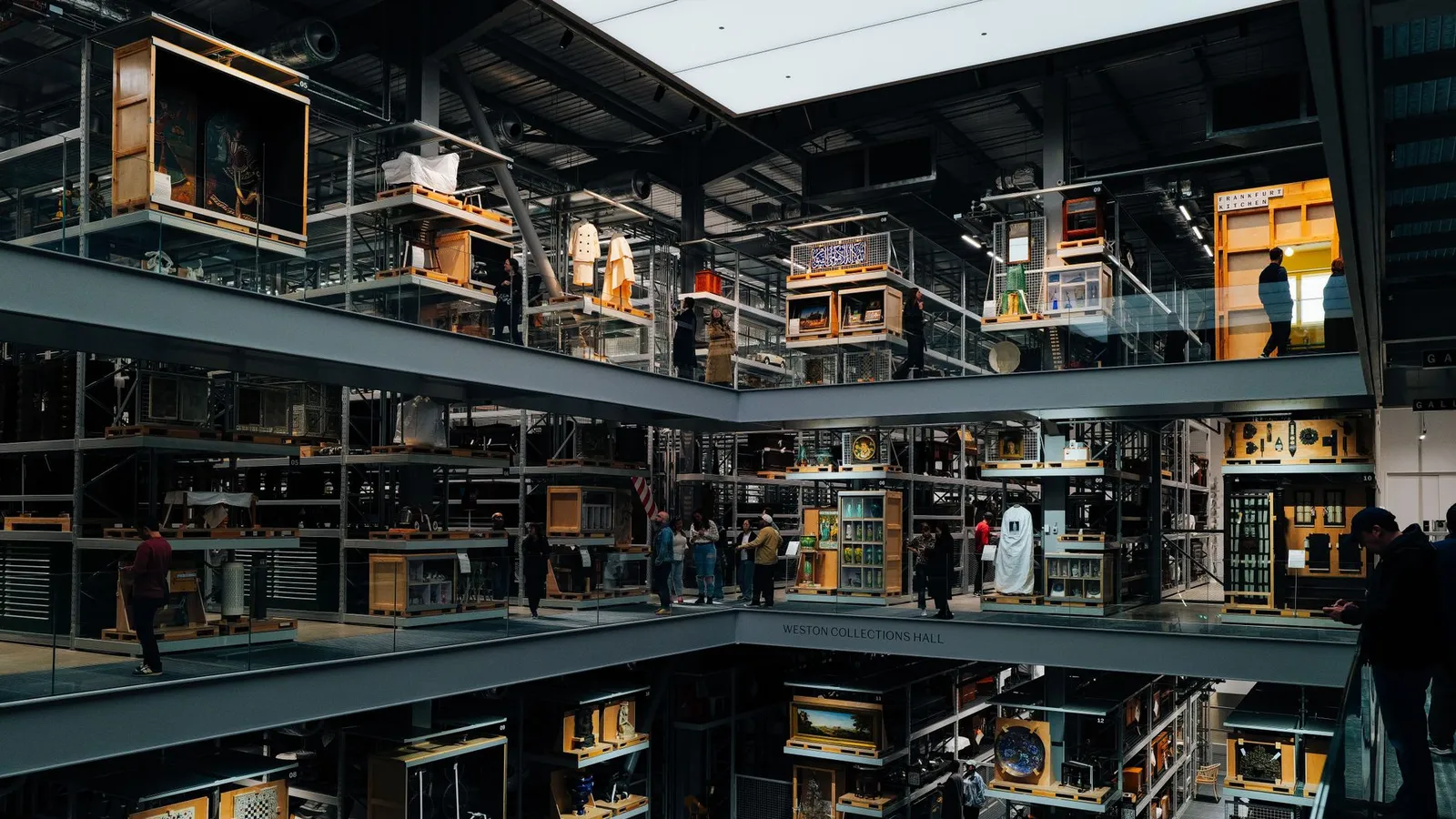 An intriguing view of a modern art museum interior with multiple floors and visitors observing exhibits.